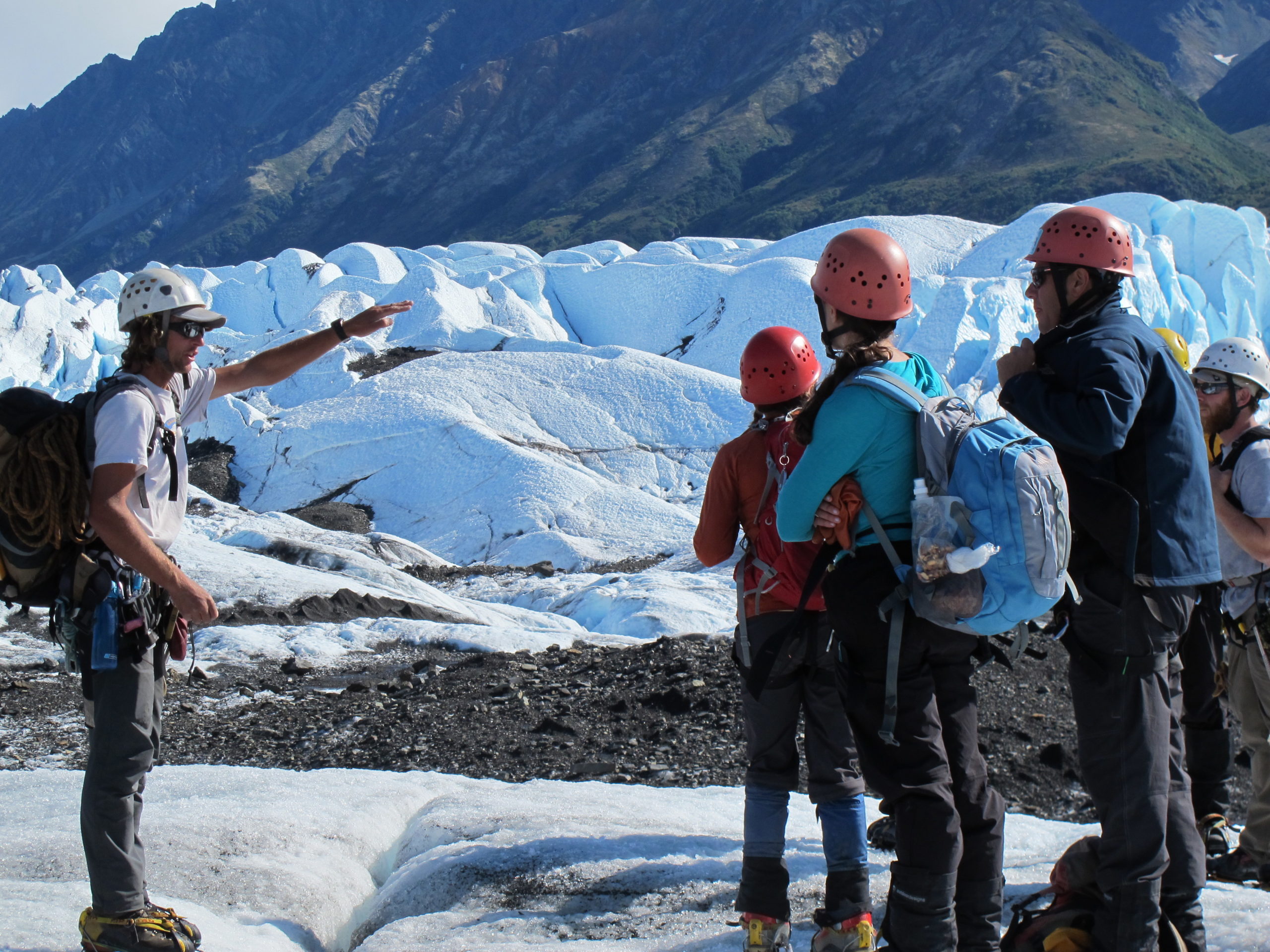 a group of people standing on top of a mountain