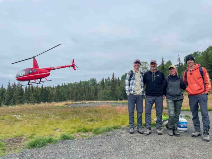 Family standing at the helipad, eagerly waiting to begin their glacier adventure in Alaska.